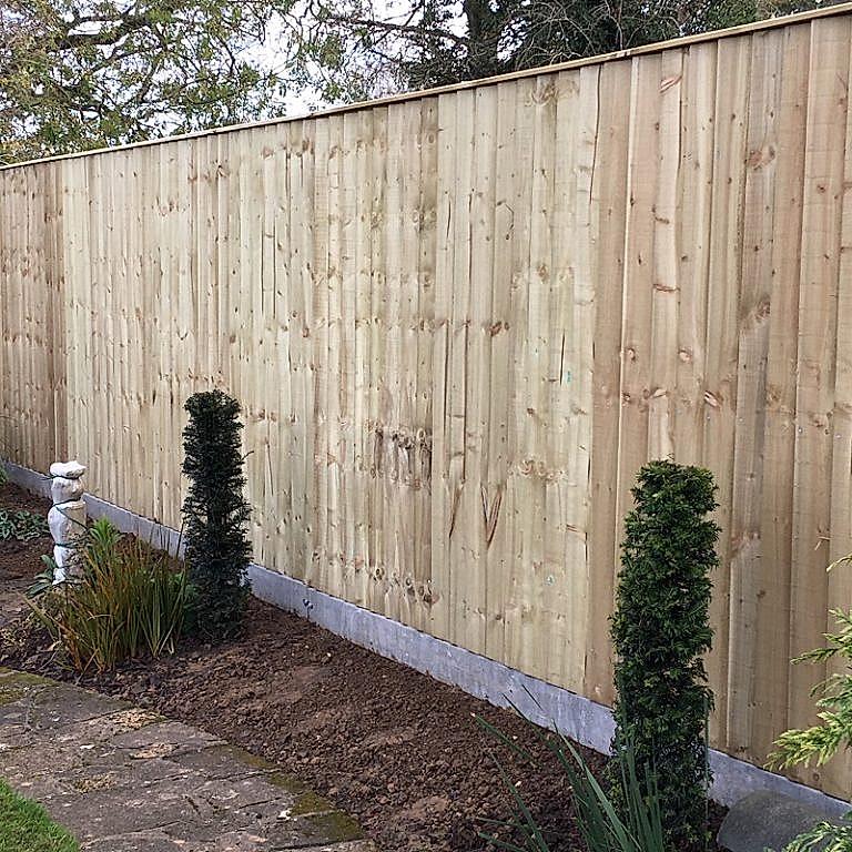 Closed board fencing with concrete posts and gravel boards.