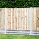 Closed board fence panels with concrete posts and 1ft concrete gravel boards.