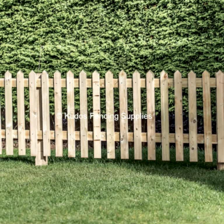 Pointed top picket fencing. Wooden picket fence.